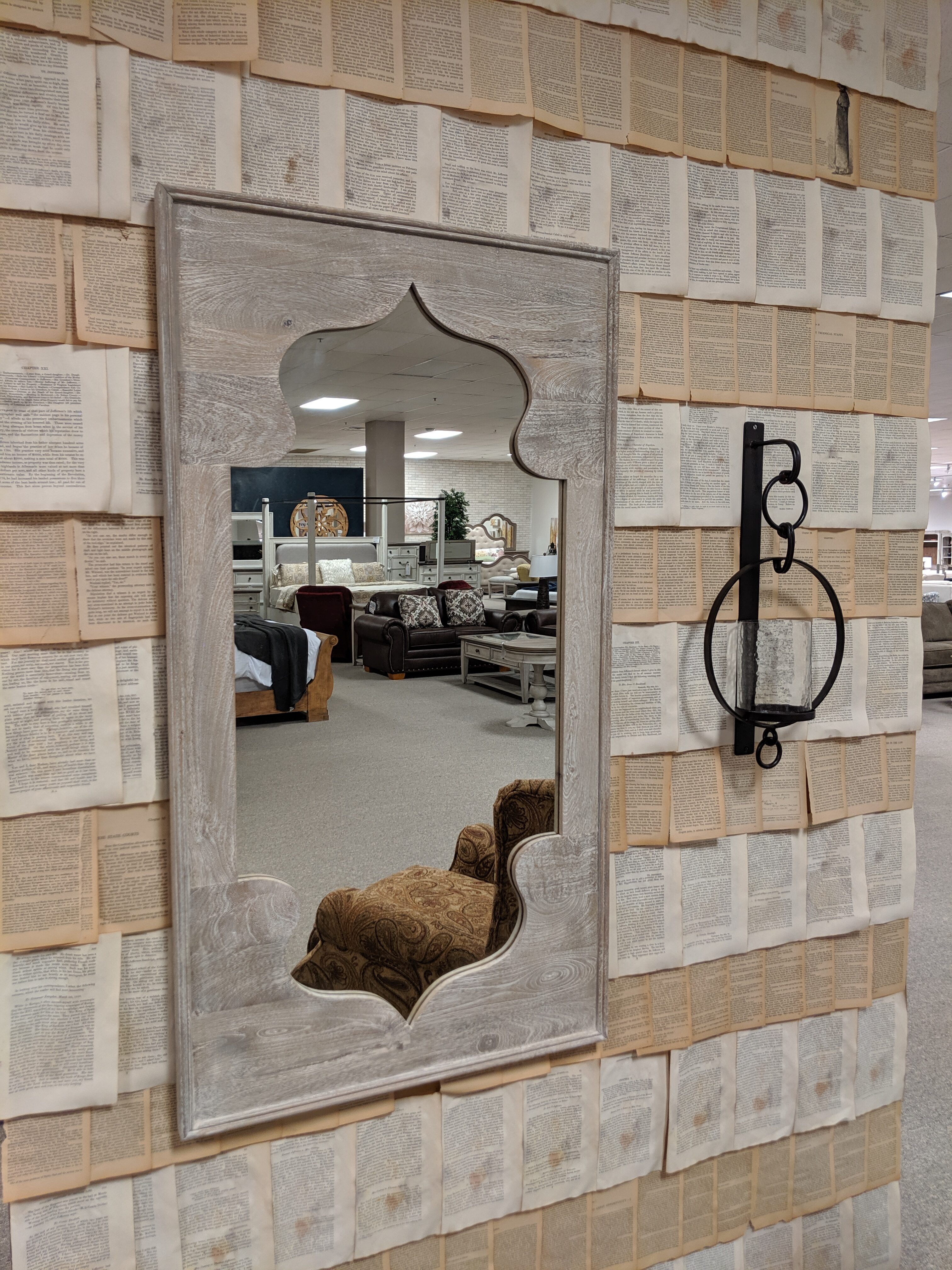 unique mirror on a wall of book pages